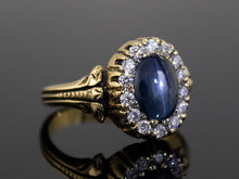  The Helena Midnight Blue Star Sapphire and Diamond Halo Ring in 18K Yellow Gold
