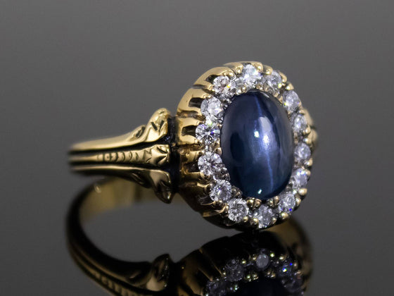 The Helena Midnight Blue Star Sapphire and Diamond Halo Ring in 18K Yellow Gold