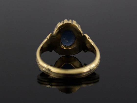 The Helena Midnight Blue Star Sapphire and Diamond Halo Ring in 18K Yellow Gold